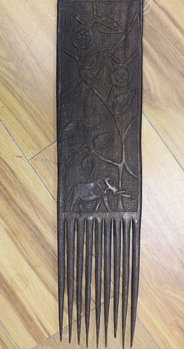 An African carved hardwood comb, Swahili, 83 cms long.